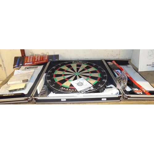 342 - A Unicorn dart board in cabinet complete with a comprehensive range of accessories