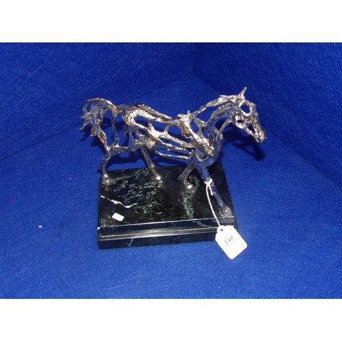 140 - A white metal model of a stallion mounted upon a black marble base