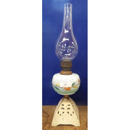 147 - A nineteenth century paraffin oil lamp, the opaline glass tank supported on a triangulated cast iron... 