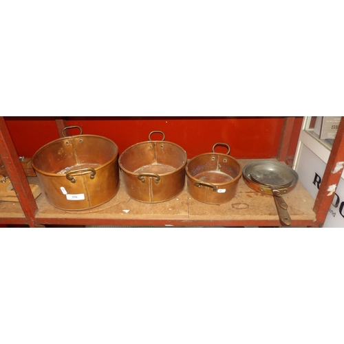 156 - A graduated set of three copper and brass mounted casserole dishes together with a graduated set of ... 