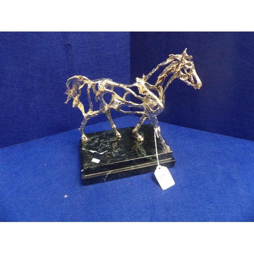 175 - A white metal model of a stallion mounted upon a black marble base