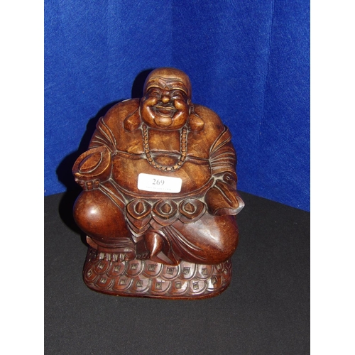 269 - A hard wood carving of a Buddha