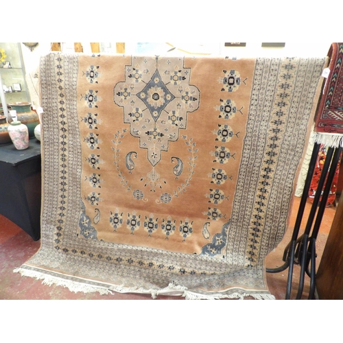 341 - An oriental floor rug decorated with geometric designs on a pink ground (183cm x 297cm)