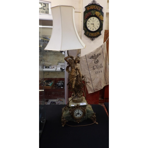 347 - A vintage onyx and gilded figural mantle clock with integrated lamp