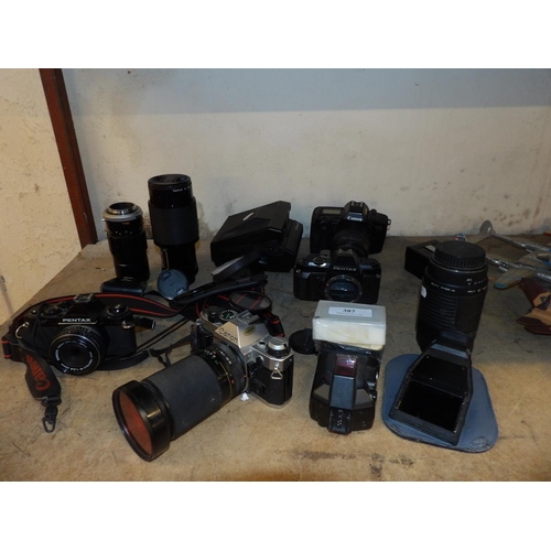 387 - An accumulation of mid century cameras and associated equipment