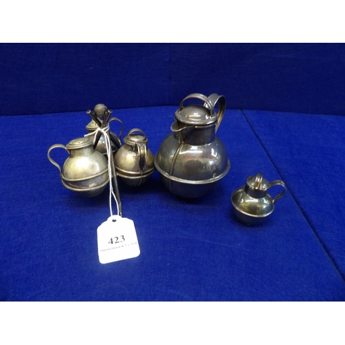 423 - A silver plated cruet modelled in the form of milk churns on a golfing themed stand together with tw... 