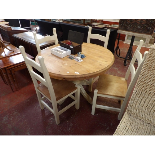 244 - A pine and white finished circular single pedestal dining table together with four matching chairs