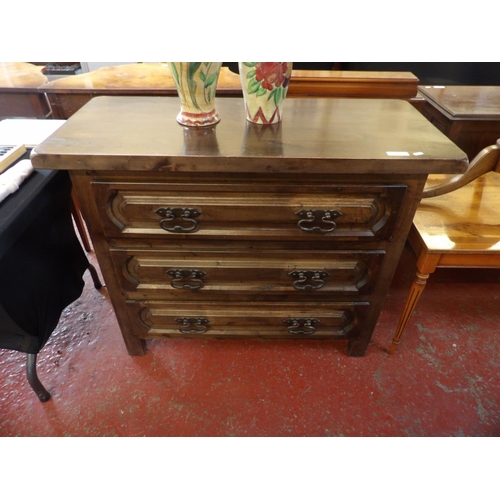 247 - An oak chest of three long drawers