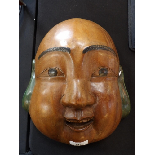 249 - A hard wood face mask depicting a buddha