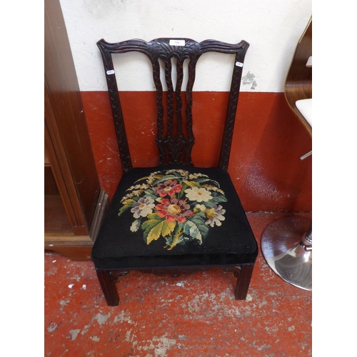 320 - A Georgian mahogany nursing chair the seat upholstered in tapestry fabric