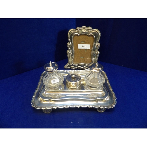 344 - A vintage silver picture frame together with a silver plated desk stand