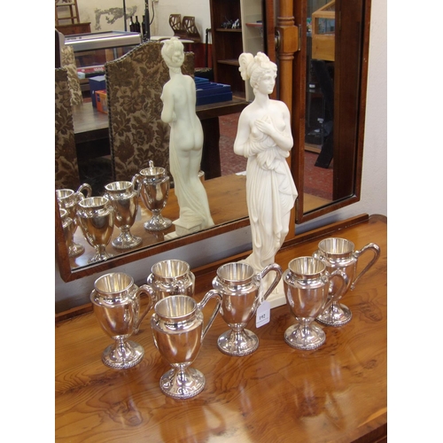 192 - A set of six Embassy silver plated toddy tankards together with a model of a semi nude classical wom... 