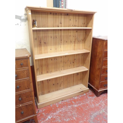 327 - A waxed pine four tier open bookcase