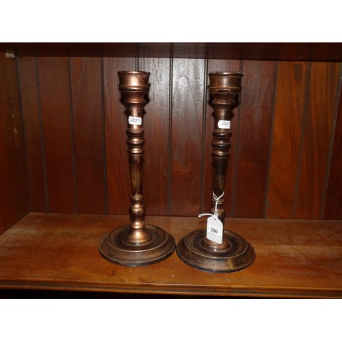 280 - A pair of bronzed candle stick holders