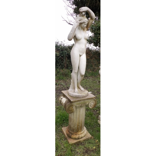 19 - A reconstituted stone statue of a nude woman on plinth modelled in the form of a classical column