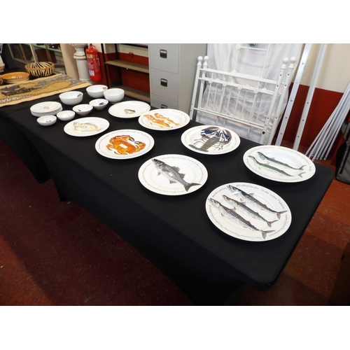 214 - A range of Richard Bramble Jersey Pottery plates, dishes and bowls decorated with fish and birds