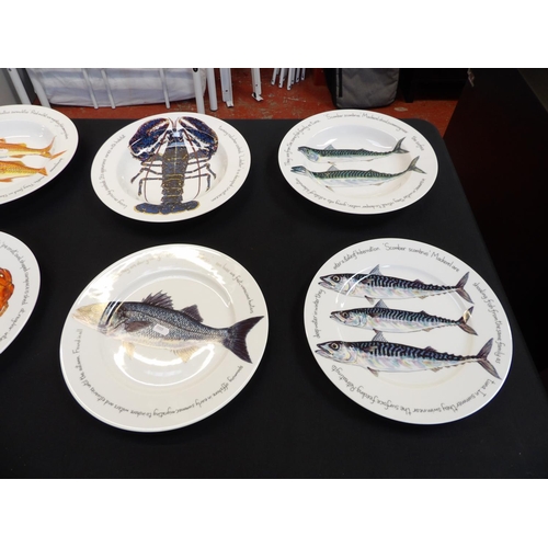 214 - A range of Richard Bramble Jersey Pottery plates, dishes and bowls decorated with fish and birds