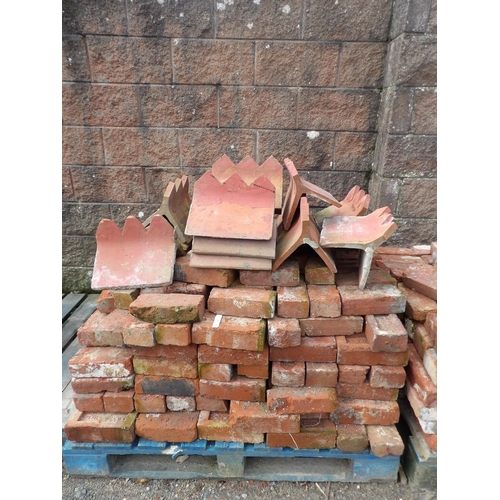 34 - A quantity of vintage Jersey and other red bricks together with a quantity of ridge tiles