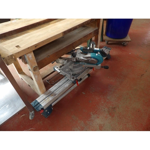 92 - A Makita 110 volt sliding compound mitre saw complete with stand