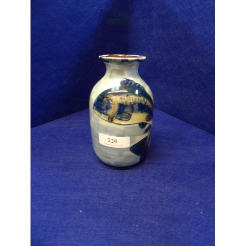 220 - A glazed pottery vase with fish decoration