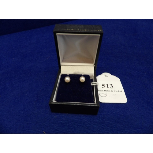 513 - A pair of 9 carat gold and solitaire pearl earrings