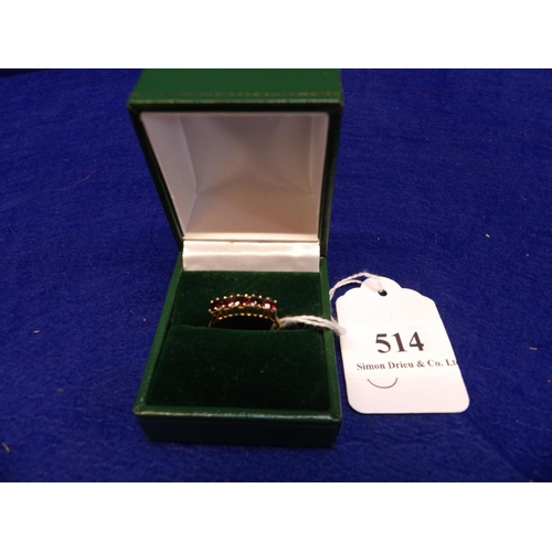 514 - A vintage 9 carat gold ring set with five red gemstones