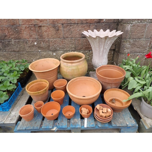 32 - An accumulation of terracotta pots, planters and saucers together with a simulated granite planter