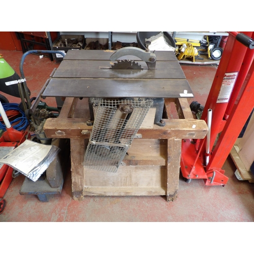 74 - A table saw mounted upon a wooden stand