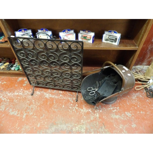 363 - A vintage copper coal scuttle, a fire screen and irons