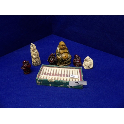 393 - A collection of buddha figures together with a miniature oriental abacus