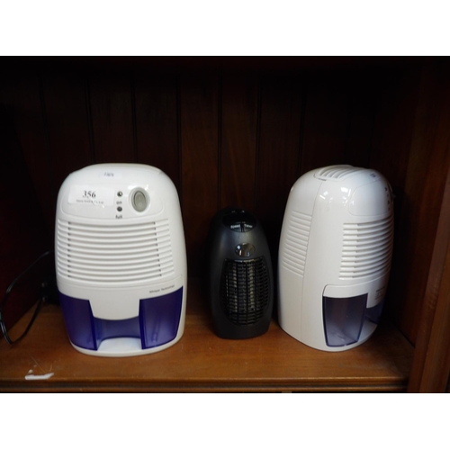 Two mini dehumidifiers together with a handy heater