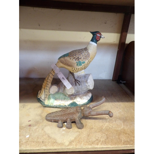 507 - A cast iron door stop modelled in the form of a cock pheasant together with a cast iron boot puller ... 