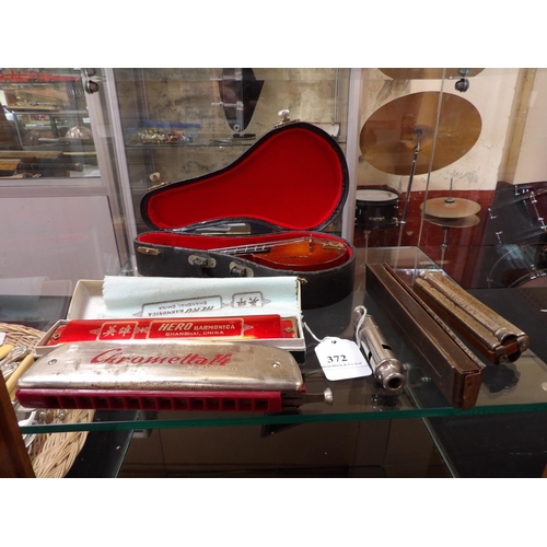 372 - A miniature mandolin and case, harmonicas, a Scout master whistle etc.