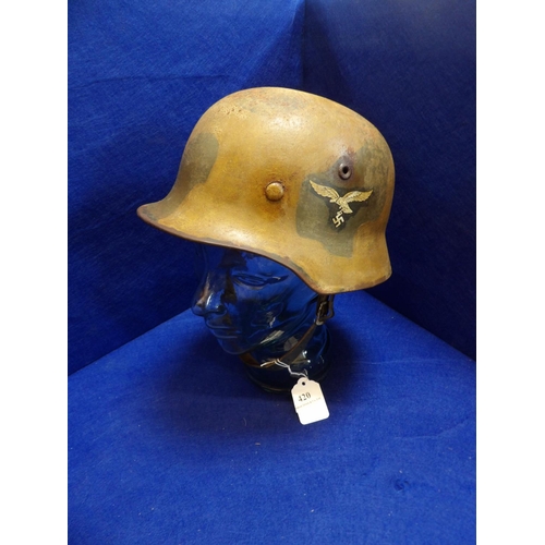 420 - A World War II German double decal Luftwaffe camouflage helmet (wearer's details inscribed on the in... 