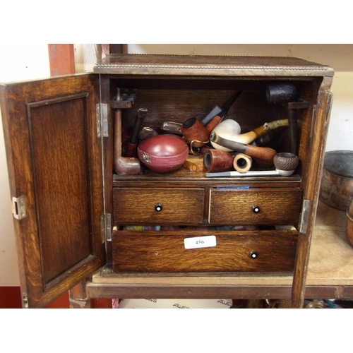 456 - An Edwardian oak smokers compactum containing a selection of smokers pipes and associated accessorie... 