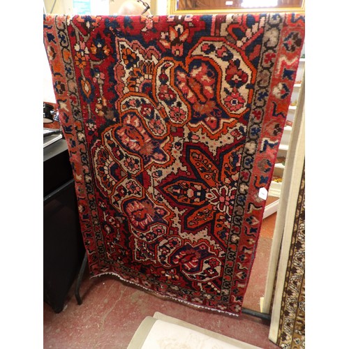 366 - An oriental carpet runner on red ground