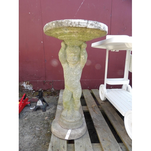 106 - A reconstituted stone bird bath, the pedestal modelled in the form of a cupid