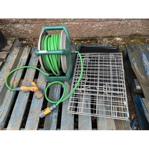 64 - A hose and reel and a folding pet cage