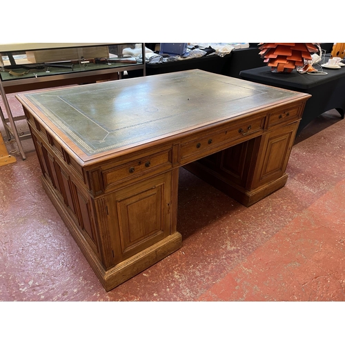 280 - An Edwardian walnut partners desk the top inlaid with green gilded and tooled leather