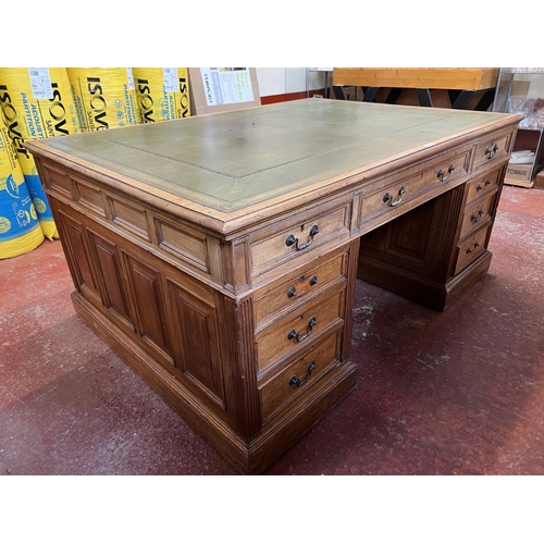 280 - An Edwardian walnut partners desk the top inlaid with green gilded and tooled leather