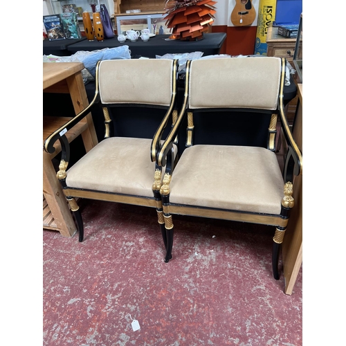 349 - A pair of vintage ebonised and gilded open armchairs