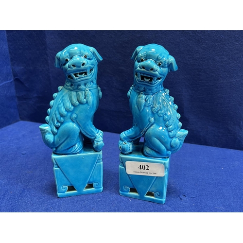 402 - A pair of salt glazed pottery models of dogs of foo