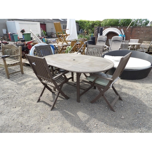 41 - A teak extending garden table together with four matching folding chairs