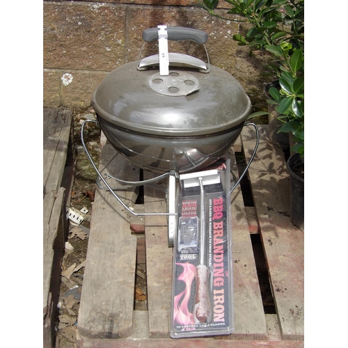 61 - A Weber portable kettle barbeque together with a barbeque branding iron