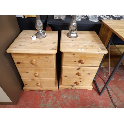 398 - A pair of waxed pine three drawer bedside chests