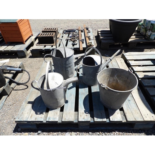 110 - Three vintage galvanised watering cans together with a similar pail