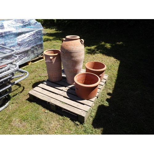 29 - A large terracotta urn in the Grecian style together with a pair of terracotta planters and two othe... 