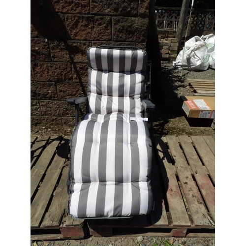 43 - A folding patio chair and cushion together with one other