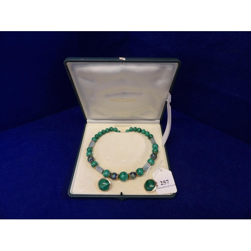 257 - A green stone necklace and matching earrings