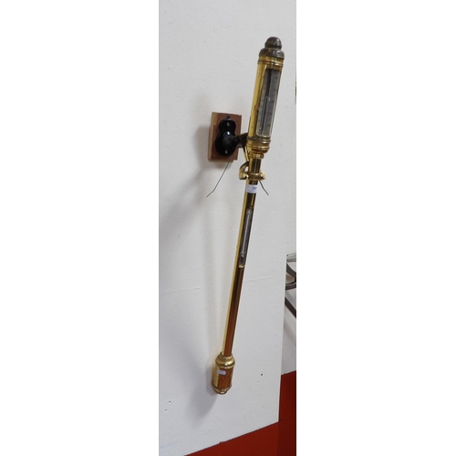 281 - A gilded stick barometer mounted within a gimballed frame and modelled in the Georgian style